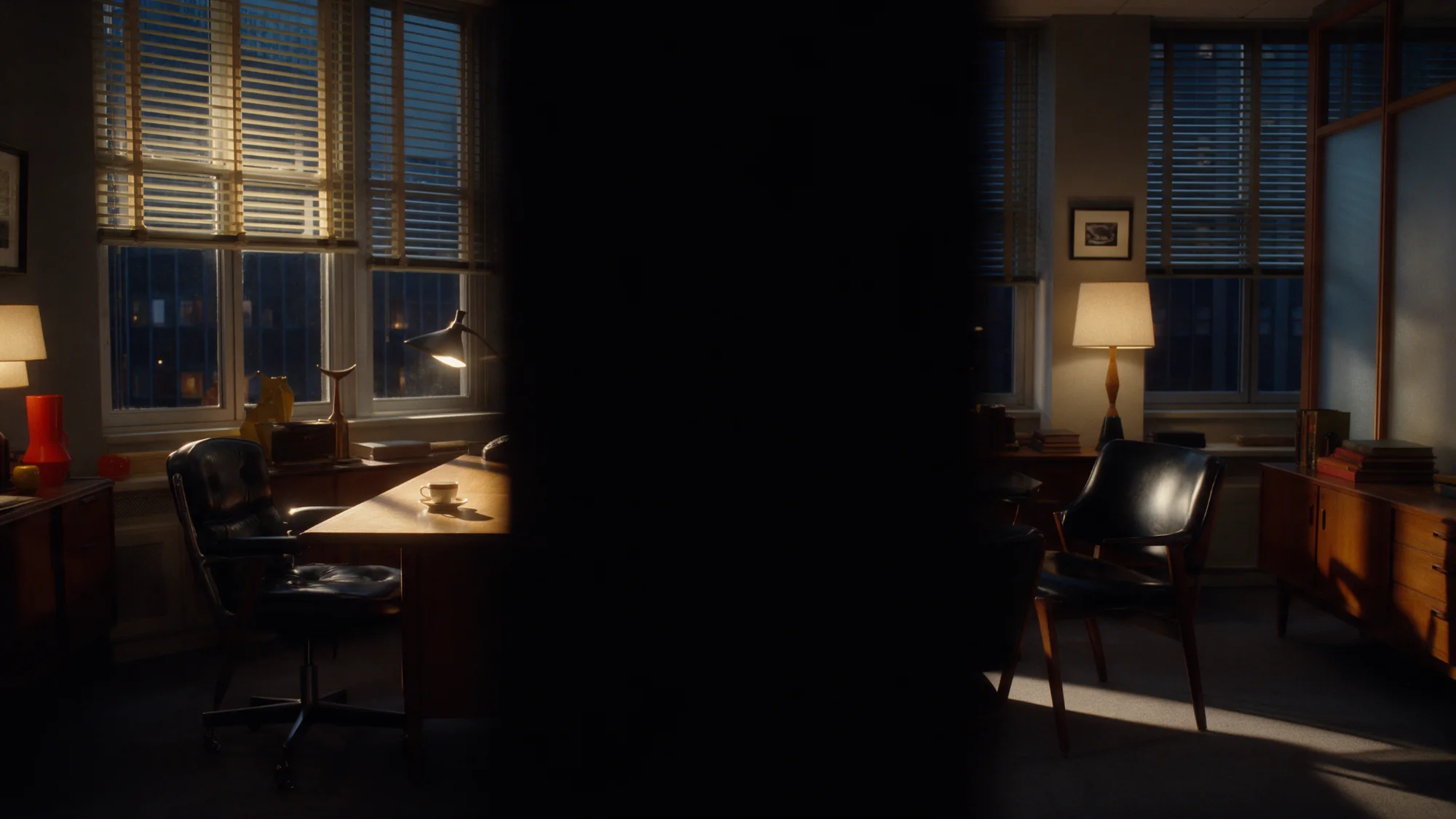 The agency office at dawn, empty and tidy, a coffee cup left on the desk.